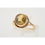 A CITRINE RING, the circular citrine within a collet setting to the rope twist surround and
