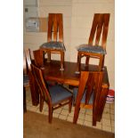 A HARDWOOD EXTENDING DINING TABLE, width 140cm x depth 90cm x height 77cm and six chairs with shaped