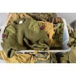 A LARGE PLASTIC STORAGE BIN CONTAINING VARIOUS ITEMS OF GENUINE MILITARY UNIFORM, to include