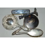 FOUR EARLY 20TH CENTURY SILVER MOUNTED DRESSING TABLE ITEMS, including a pique hand mirror, together