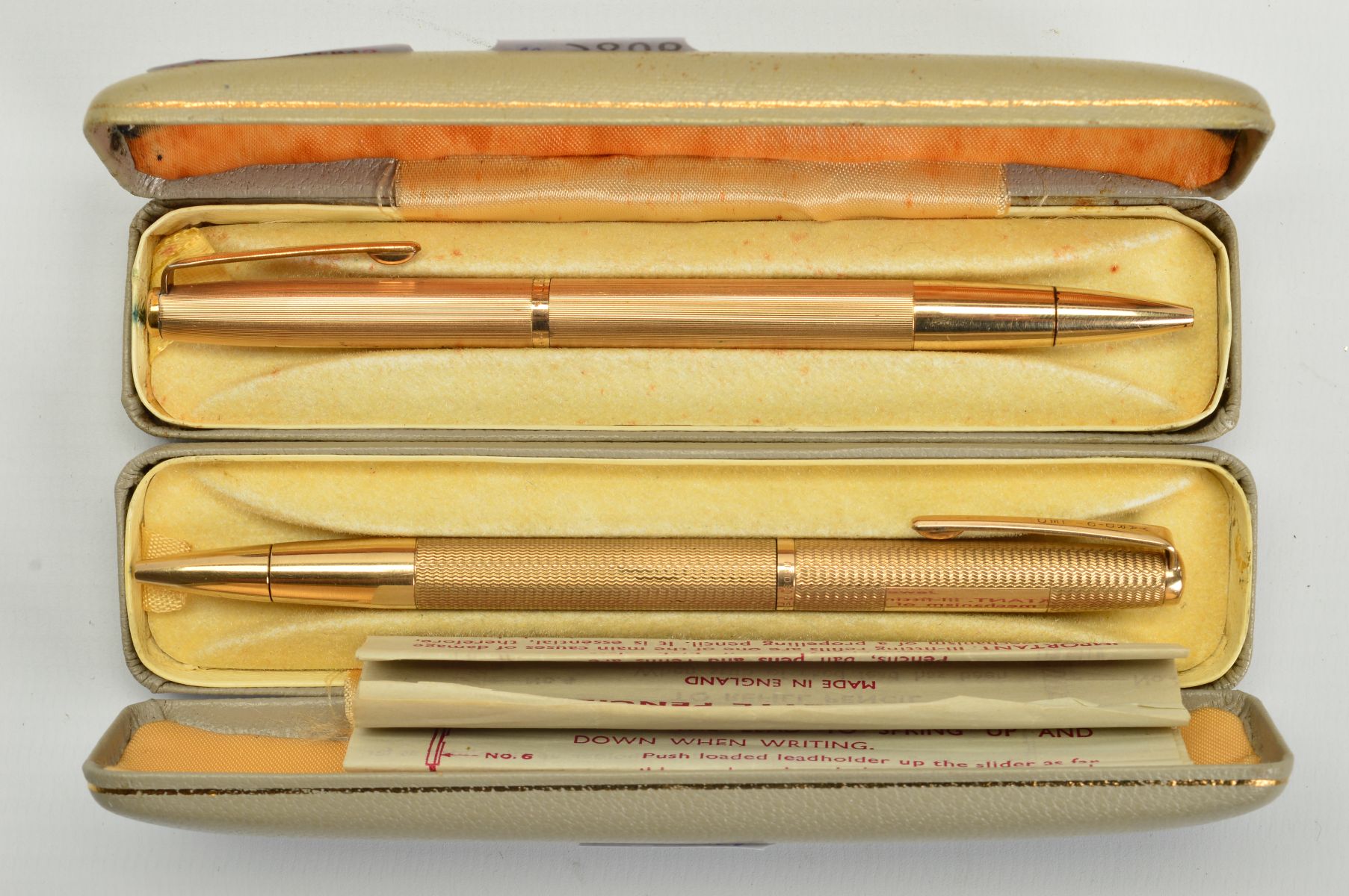 TWO CASED YARD-O-LED RETRACTABLE PENS, the first a 9ct gold engine turned case, with hallmark for