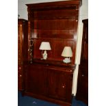 A VICTORIAN MAHOGANY BOOKCASE, the top with four adjustable open shelves, above double panelled