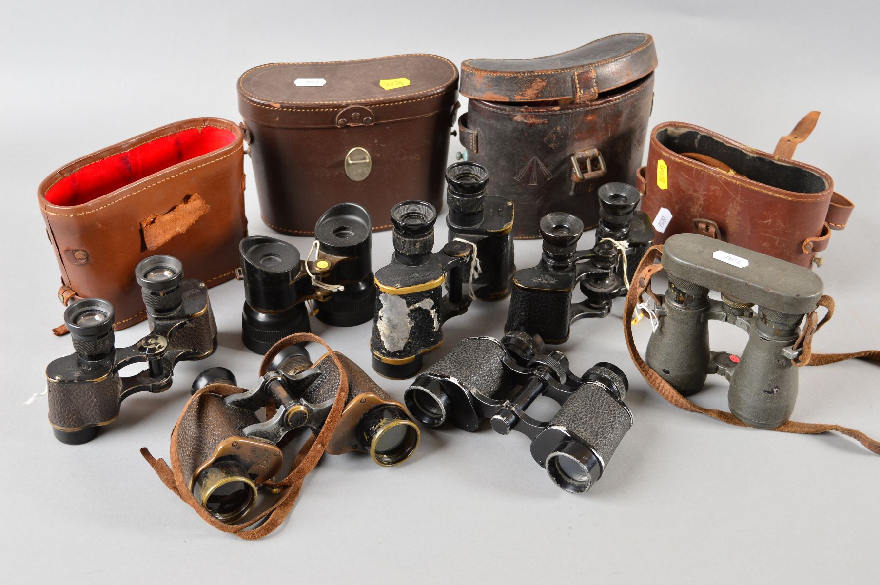 SEVEN PAIRS OF MILITARY BINOCULARS, some with leather cases, no all matching the optics, makers