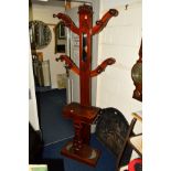 A VICTORIAN MAHOGANY SKELETON HALL STAND, with eight coat hooks, central mirror, hinged