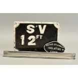 A WALL MOUNTED CAST IRON STOP VALVE SIGN, raised white lettering and edge on black background,