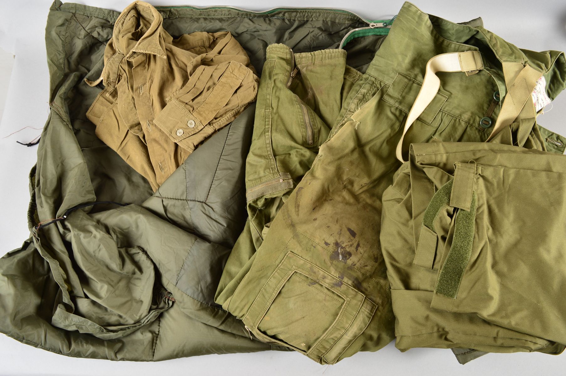 A BOX CONTAINING A MILITARY ISSUE GREEN BIVOUAC STYLE SLEEPING BAG, Air Crew trousers, Military