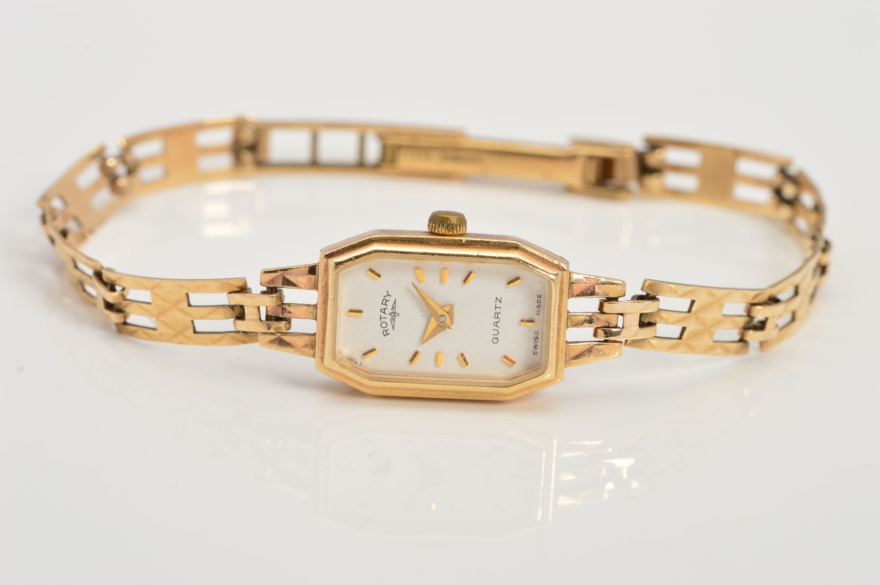 A LADY'S 9CT GOLD ROTARY WRIST WATCH, the elongated octagonal head with white face and baton hour