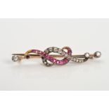 AN EARLY 20TH CENTURY RUBY AND DIAMOND BAR BROOCH, designed as two over lapping curved lines, one