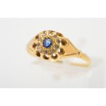 A LATE VICTORIAN 18CT GOLD SAPPHIRE AND DIAMOND RING, the central circular blue sapphire within a