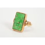 A 9CT GOLD JADE RING, designed as a rectangular carved jade panel within a collet setting to the