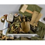 A LARGE PLASTIC STORAGE BOX CONTAINING A LARGE NUMBER OF MILITARY ITEMS, including many pistol