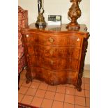 A LATE VICTORIAN WALNUT SERPENTINE CHEST OF FOUR GRADUATING DRAWERS, the top drawer with triple