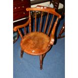 AN EDWARDIAN MAHOGANY CIRCULAR SEATED SPINDLE BACK ARMCHAIR