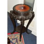 A 20TH CENTURY EBONISED JARDINIERE STAND with a circular fruitwood top, height 75cm