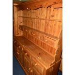 A PINE KITCHEN DRESSER, the top with four drawers above a base section with four drawers and four