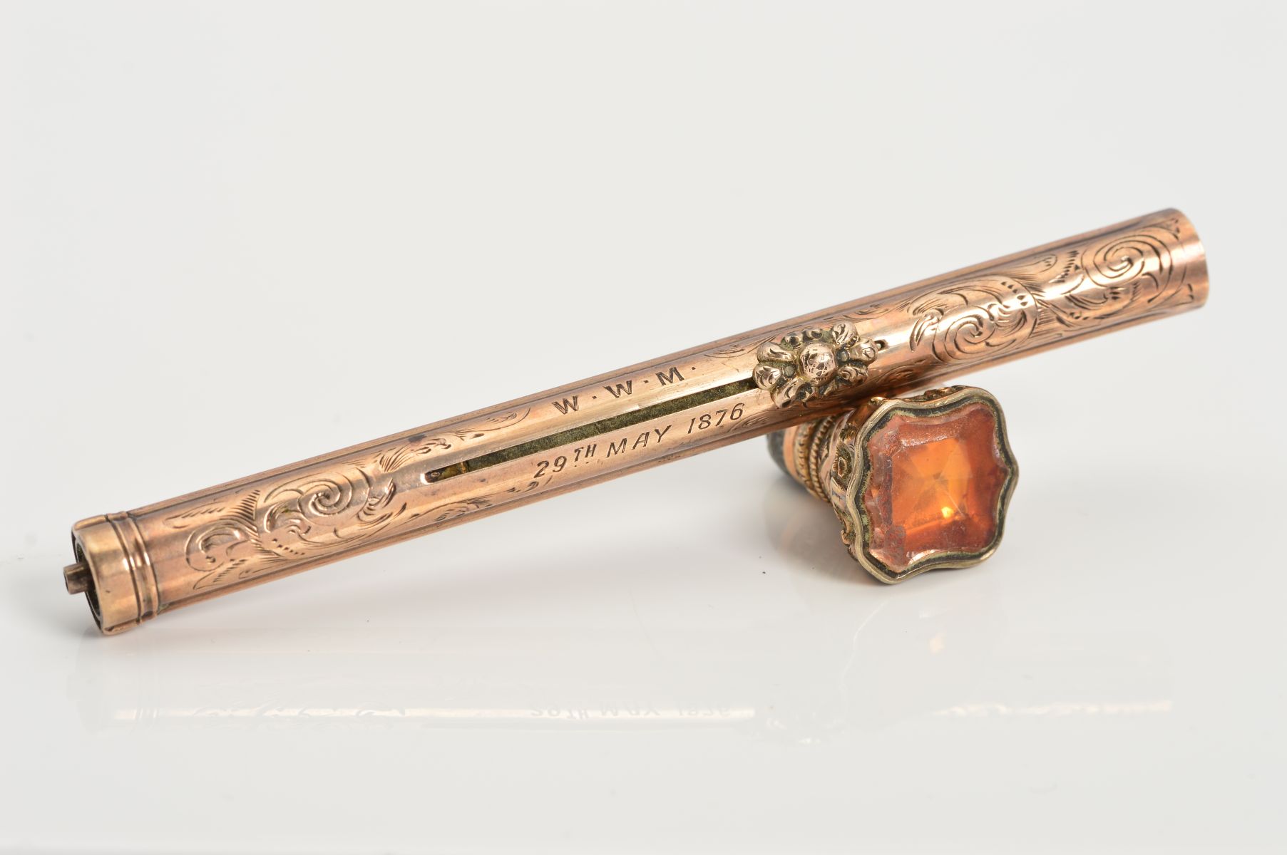 A MID VICTORIAN GOLD PLATED RETRACTABLE PEN/PENCIL, the cylindrical case engraved with scrolling