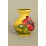 A SMALL MOORCROFT POTTERY VASE, 'Hibiscus' pattern on green/yellow ground, impressed marks to