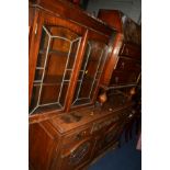 AN EDWARDIAN OAK SIDEBOARD with foliate decoration, raised back, three various drawers and double