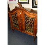 A FRENCH EARLY 20TH CENTURY OAK COLOURED LEAD GLAZED DOUBLE DOOR BOOKCASE with foliate decoration,