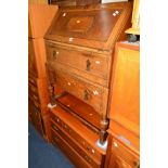 AN OAK FALL FRONT BUREAU with two drawers and a cherrywood chest of three drawers (2)