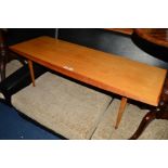 GORDON RUSSELL, BROADWAY WORKS, a teak coffee table, with shaped sides on four square tapering legs,