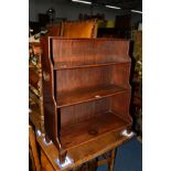 A GEORGIAN MAHOGANY WATERFALL OPEN BOOKCASE, with brass drop handles on square legs, width 66.5cm