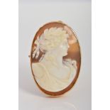 A CAMEO BROOCH, of oval outline, carved to depict a bacchante in profile, to the plain collet