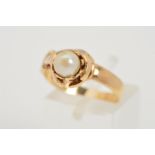 A 9CT GOLD CULTURED PEARL RING, designed as a hand holding a cultured pearl to the plain band with