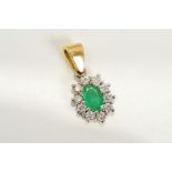 AN 18CT GOLD, EMERALD AND DIAMOND CLUSTER PENDANT, designed as a central oval emerald within a