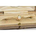 AN OPAL BROOCH, designed as an elongated tapered panel with scrolling openwork decoration and