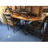 A MCINTOSH TEAK OVAL EXTENDING DINING TABLE, four chairs, a Nathan double door cupboard and a