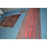 A LATE 19TH CENTURY TEKKE RUG, red and black ground, 281cm x 105cm, together with two similar rugs