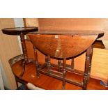 AN EARLY 20TH CENTURY OAK OVAL TOPPED DROP LEAF TABLE and a Georgian mahogany dish topped tripod
