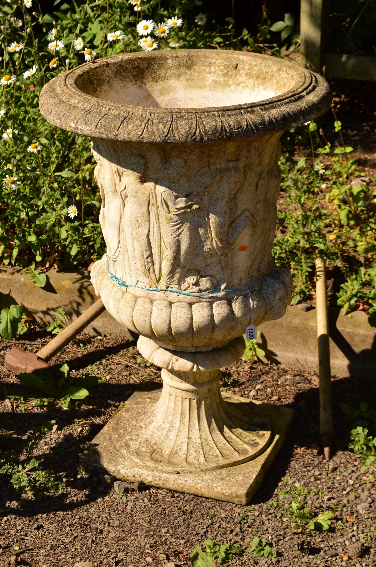 A LARGE COMPOSITE URN WITH GREEK DECORATION on a seperate base, diameter 63cm x height 92cm