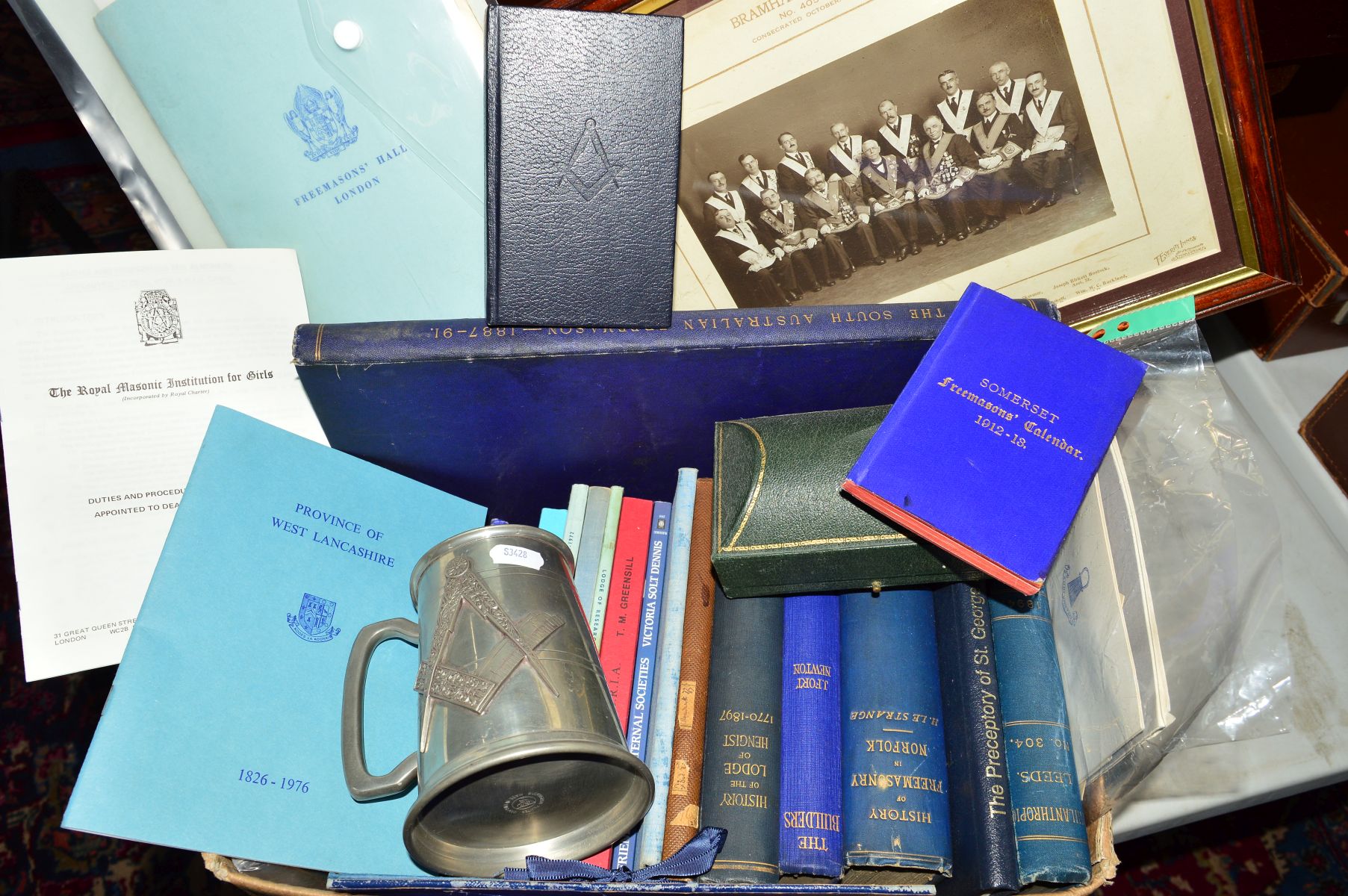 A BOX OF FREEMASONS BOOKS, PAMPHLETS, pewter tankard, etc, including a framed photograph ofm members