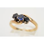 A 9CT GOLD THREE STONE SAPPHIRE RING, designed as three claw set circular sapphires set on an