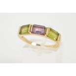 AN AMETHYST AND PERIDOT RING, designed as a central rectangular amethyst flanked by a rectangular