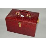 A RECTANGULAR RED CROCODILE SKIN VANITY CASE, carry handle to the top, mirror to interior, lacks