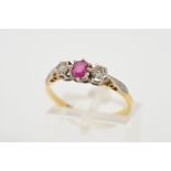 AN 18CT GOLD RUBY AND DIAMOND RING, the central claw set circular ruby flanked by illusion set