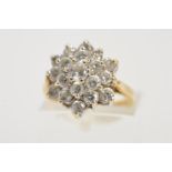 A 9CT GOLD CUBIC ZIRCONIA CLUSTER RING, designed as a tiered cluster of circular colourless cubic