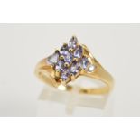 A 9CT GOLD GEM DRESS RING, claw set with a central cluster of marquise shape blue gems, assessed