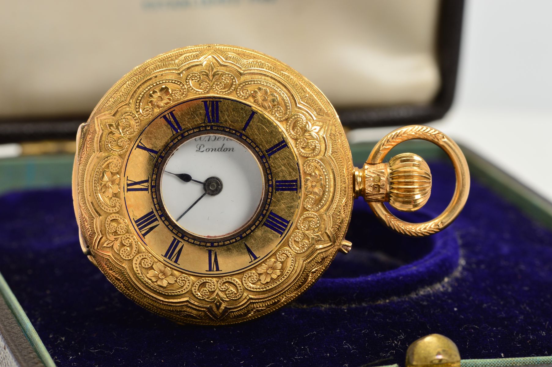 A CASED 18CT LADIES HALF HUNTER FOB WATCH BY J.W. BENSONS, foliate engraved with blind cartouche,