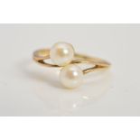 A 9CT GOLD CULTURED PEARL RING, designed as two cultured pearls in a crossover design to two