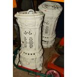 TWO MATCHING WHITE PAINTED CAST IRON CYLINDRICAL STOVES (sd)