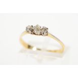 A THREE STONE DIAMOND RING designed as three claw set graduated old cut diamonds to the tapered