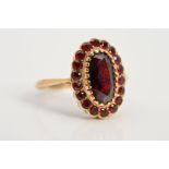 A 9CT GOLD RED PASTE CLUSTER RING, designed as a central oval red paste within a circular red