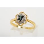 AN 18CT GOLD CLUSTER RING designed as an oval blue gem, assessed as sapphire within a single cut