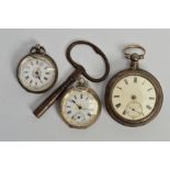 THREE EARLY 20TH CENTURY SILVER OPEN FACE POCKET WATCHES AND A CLOCK KEY, all with Roman numeral