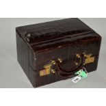 A RECTANGULAR CROCODILE SKIN EFFECT LEATHER VANITY CASE, brown lined interior, lacks fittings,