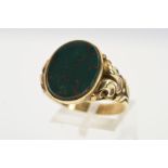 A BLOODSTONE SIGNET RING, designed as an oval bloodstone within a collet setting to the acanthus